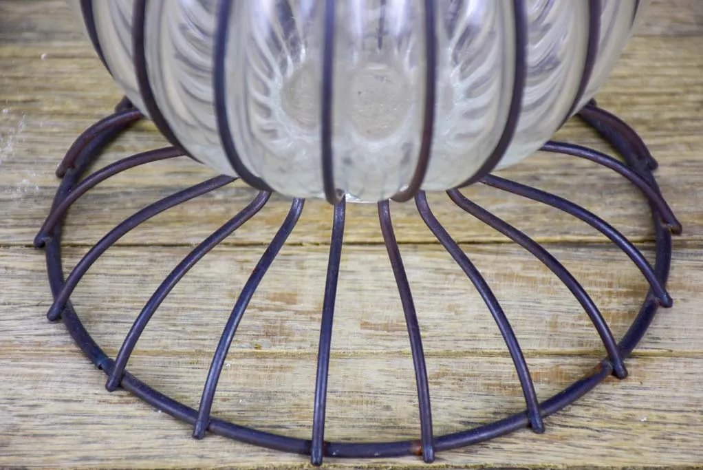 Tall blown glass vase in metal frame